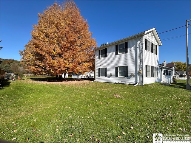 rear view of property with a yard