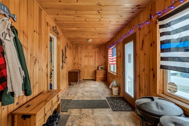 mudroom with wooden ceiling and wood walls