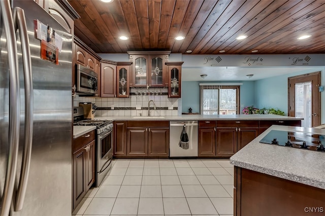 kitchen with stainless steel appliances, sink, wooden ceiling, and light tile patterned flooring