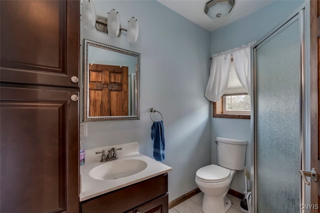 bathroom with toilet, vanity, tile patterned flooring, and walk in shower