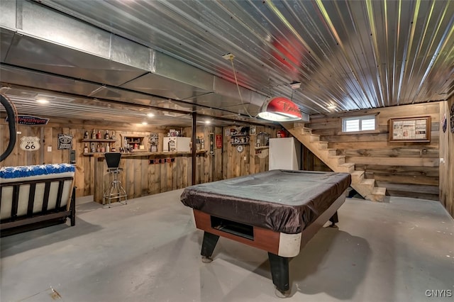 playroom with concrete flooring, wooden walls, and pool table