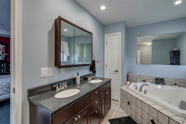 bathroom featuring vanity, tiled bath, and tile patterned flooring