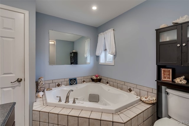 bathroom with toilet and tiled bath