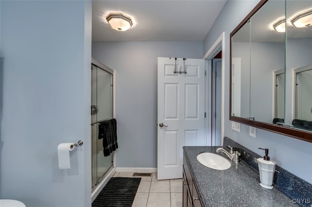 bathroom featuring vanity, tile patterned floors, and an enclosed shower