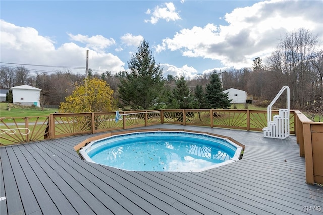 view of swimming pool featuring a wooden deck