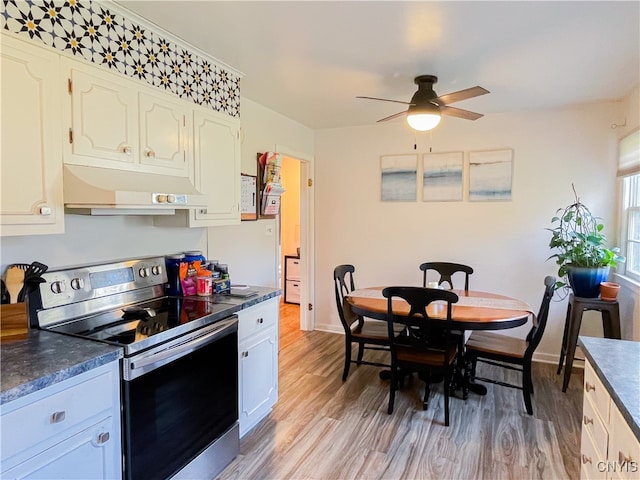 kitchen with white cabinetry, stainless steel electric range, ceiling fan, and light hardwood / wood-style flooring