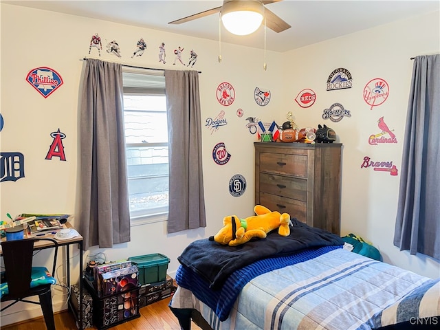 bedroom with wood-type flooring and ceiling fan