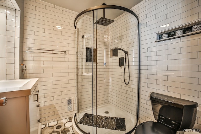 bathroom with tile walls, vanity, and a shower with shower door