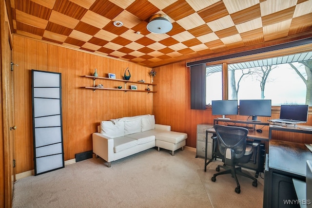 carpeted home office with wooden ceiling and wood walls