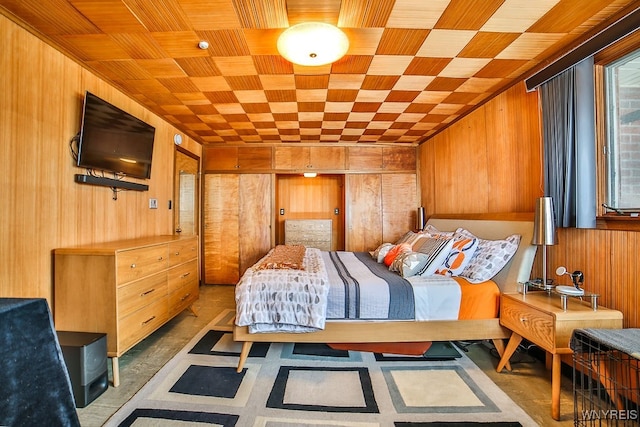 bedroom featuring wood walls