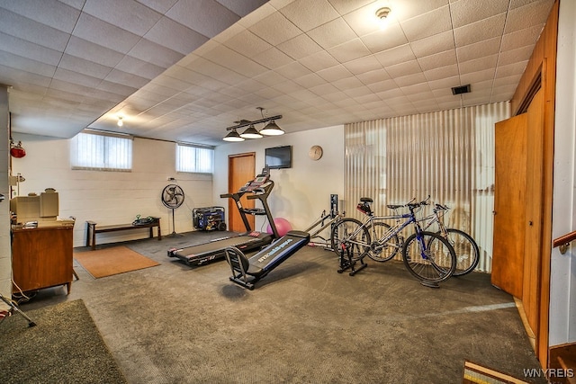 workout room featuring dark colored carpet