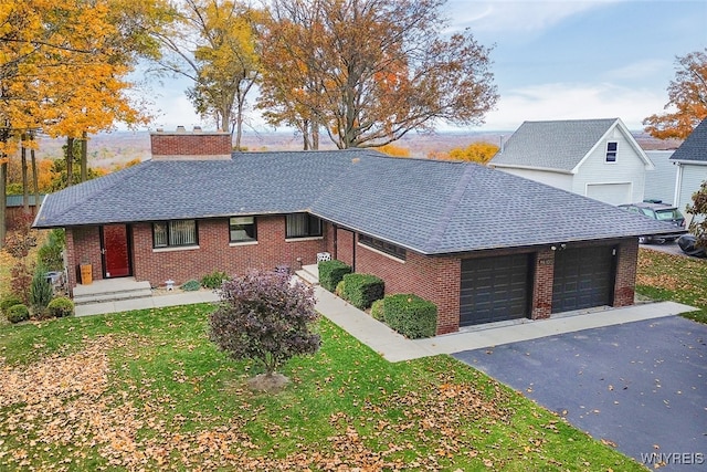 view of front of property featuring a garage and a front lawn