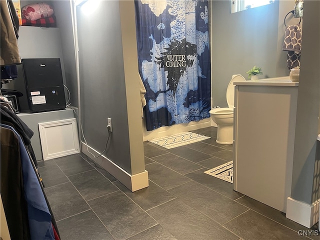 bathroom featuring tile patterned flooring, vanity, and toilet