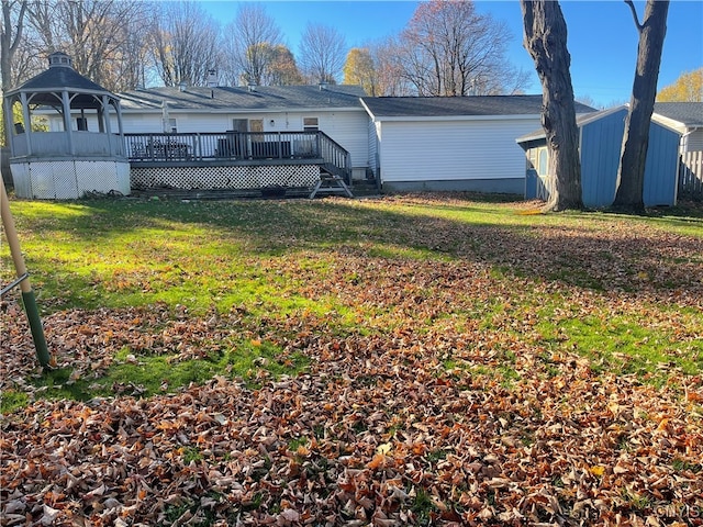 rear view of property with a lawn and a wooden deck