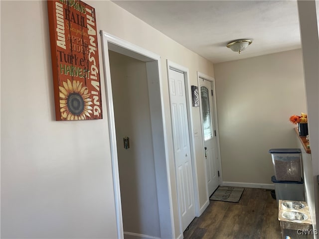 corridor with dark hardwood / wood-style flooring