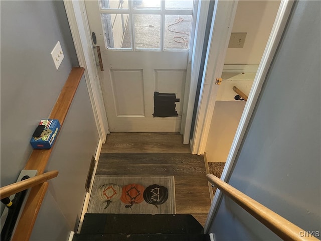 stairway with hardwood / wood-style floors