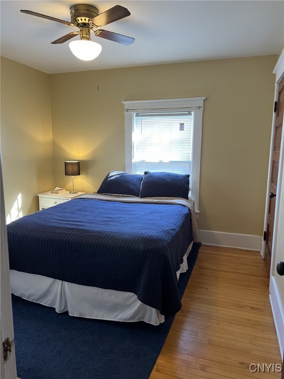 bedroom with light wood-type flooring and ceiling fan