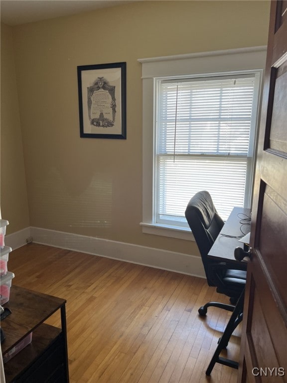 home office featuring a wealth of natural light and light hardwood / wood-style floors