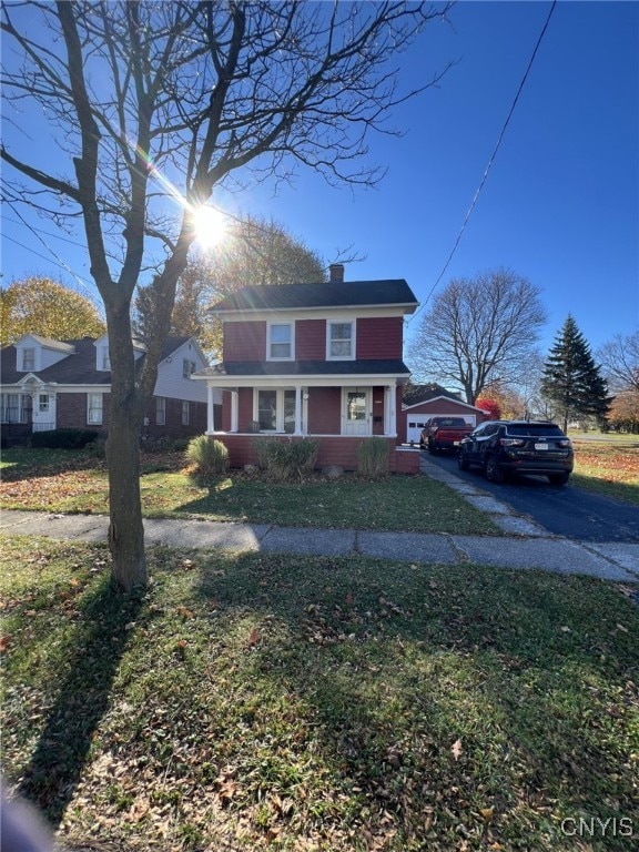 view of front of home featuring a front lawn and covered porch