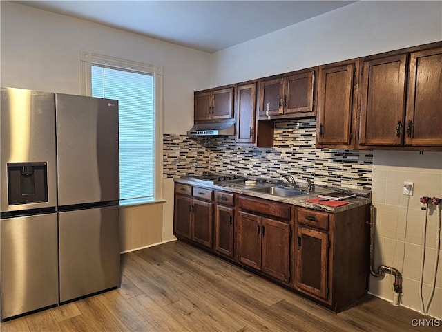 kitchen featuring hardwood / wood-style floors, a healthy amount of sunlight, sink, and appliances with stainless steel finishes