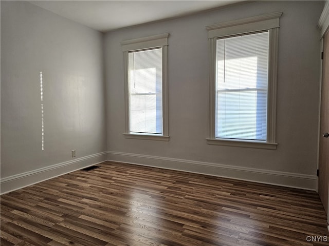 spare room with dark wood-type flooring