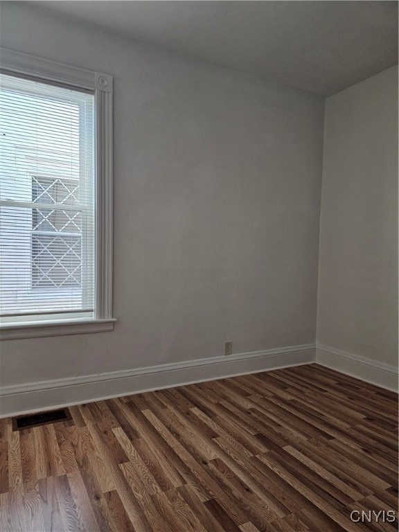 spare room featuring dark hardwood / wood-style flooring