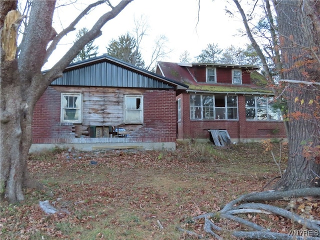 back of house featuring a sunroom