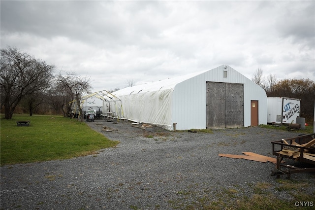 view of outdoor structure with a lawn