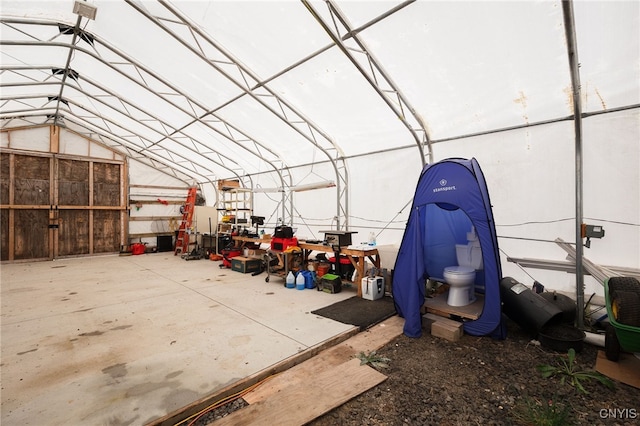 miscellaneous room with concrete floors and vaulted ceiling