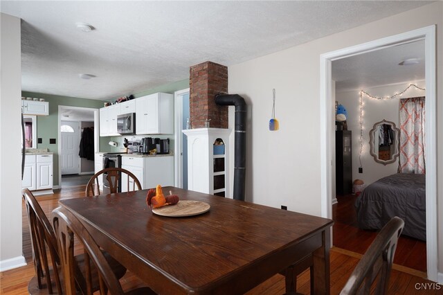 dining area featuring hardwood / wood-style floors and a textured ceiling