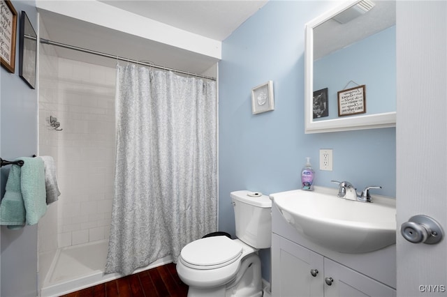 bathroom featuring a shower with curtain, wood-type flooring, vanity, and toilet