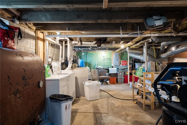 basement featuring electric panel and washing machine and dryer