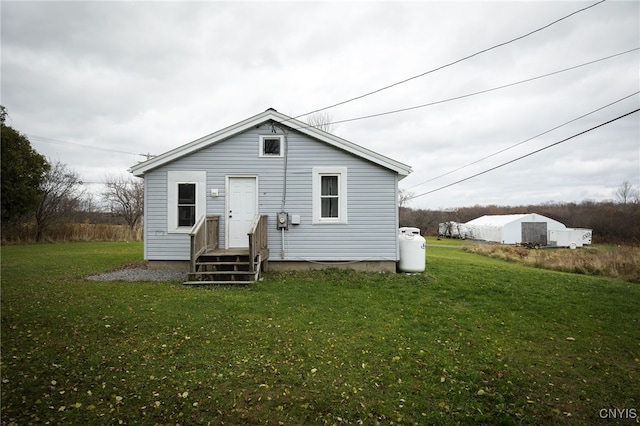 back of property with a lawn