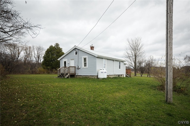 rear view of house featuring a yard