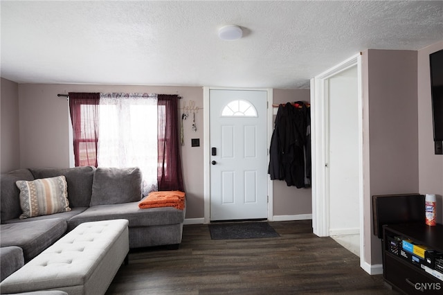 foyer featuring dark wood-type flooring and a textured ceiling