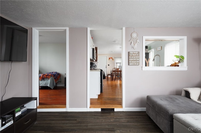 interior space featuring a textured ceiling and dark hardwood / wood-style floors