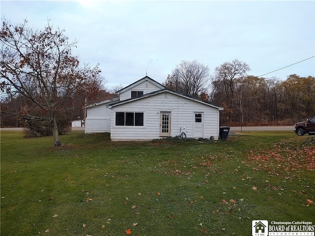 view of side of home with a yard