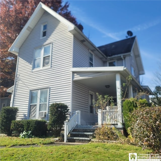 view of side of home with a lawn