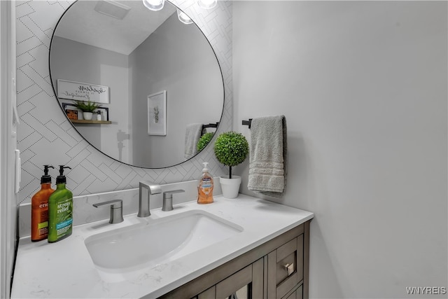 bathroom featuring vanity and tasteful backsplash