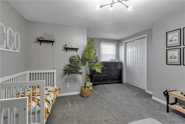 bedroom with carpet flooring, a textured ceiling, and a closet