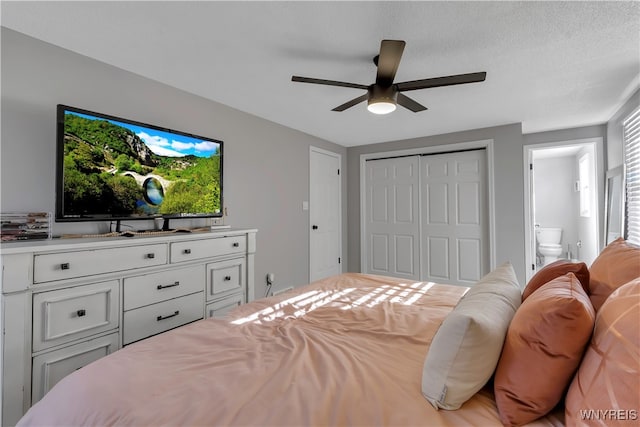 bedroom featuring ceiling fan, connected bathroom, a closet, and a textured ceiling