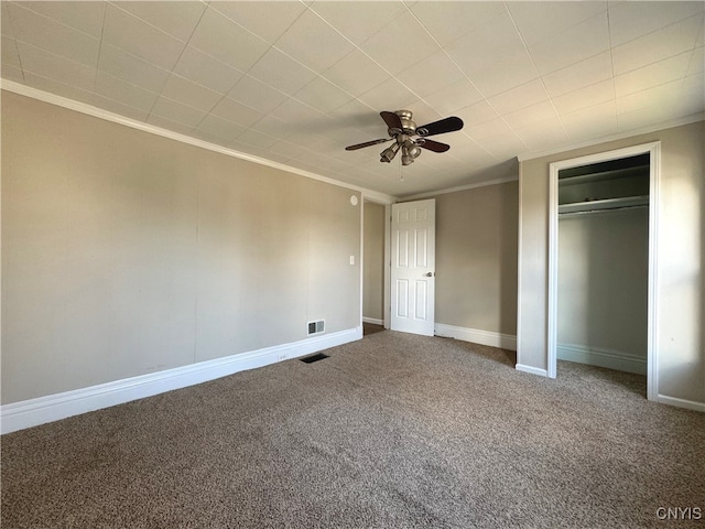 unfurnished bedroom with ceiling fan, crown molding, and carpet