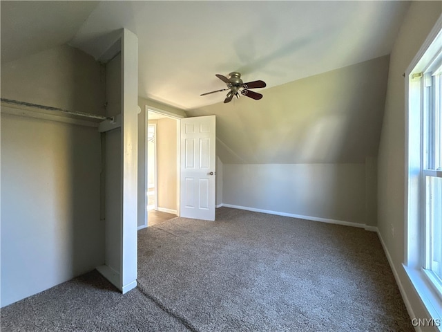 unfurnished bedroom featuring carpet, vaulted ceiling, and ceiling fan