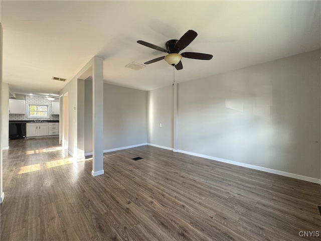 unfurnished room featuring dark wood-type flooring, ceiling fan, and sink