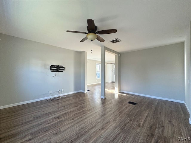 empty room featuring dark hardwood / wood-style flooring and ceiling fan