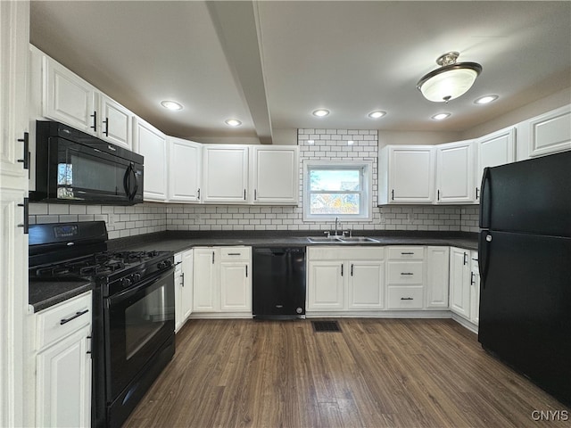 kitchen with black appliances, dark hardwood / wood-style flooring, and white cabinets