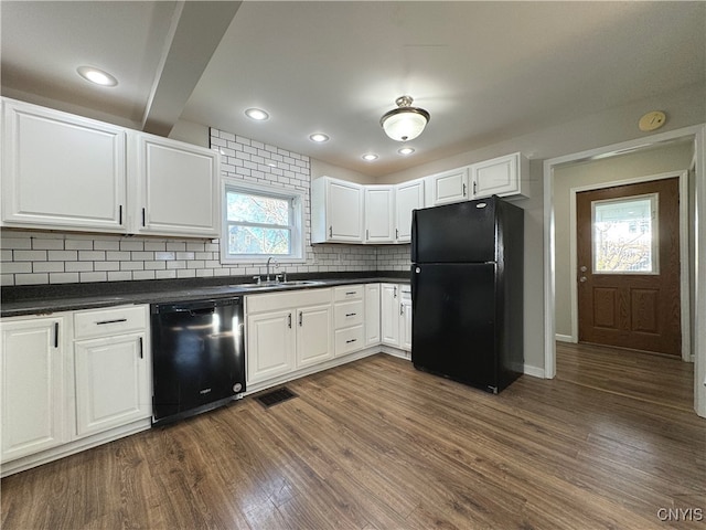 kitchen with dark wood-type flooring, white cabinetry, black appliances, and tasteful backsplash