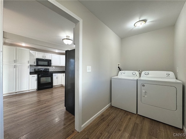 clothes washing area featuring dark wood-type flooring and separate washer and dryer