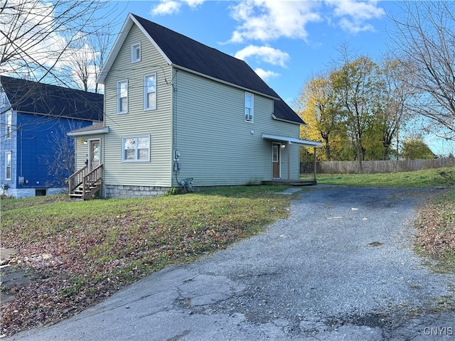 view of side of home with a lawn