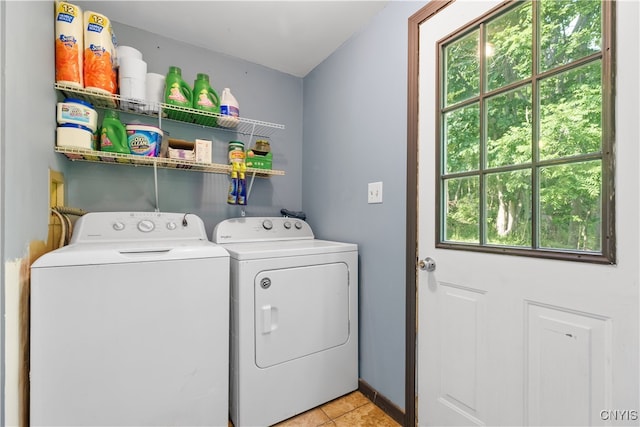 washroom with separate washer and dryer, plenty of natural light, and light tile patterned floors